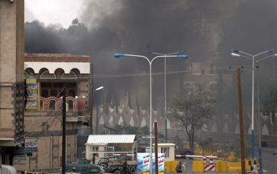 In this photo released by Yemen News Agency smoke rises  from the U.S. Embassy in San’a, Yemen, on Wednesday after a car bomb  hit the front gate of the compound.  (Associated Press / The Spokesman-Review)