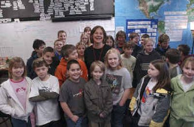 
Debbie Lohrey, center, of Red Cross collected the money raised by Winton Elementary's fifth-grade class as a donation for the victims of the tsunami. 
 (Kathy Plonka / The Spokesman-Review)