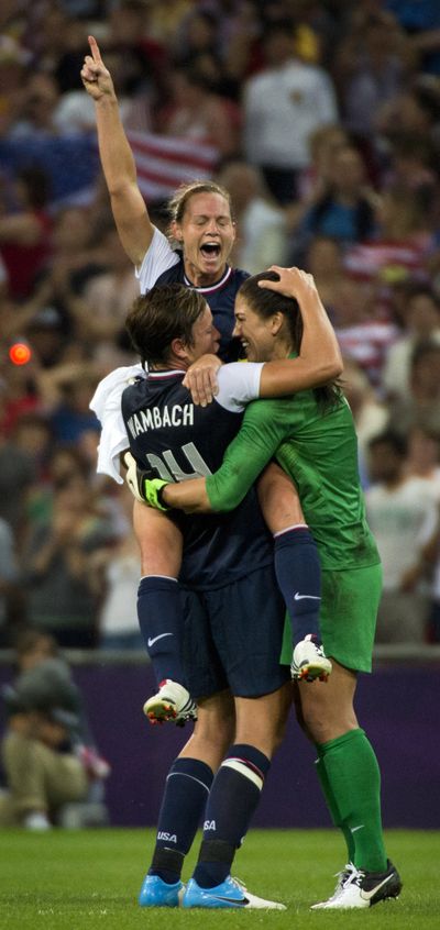 Christine Rampone leaps into the arms of Abby Wambach and goalie Hope Solo after the United States defeated Japan 2-1 on Thursday for the women’s soccer gold medal. (Brian Peterson / Minneapolis Star Tribune)