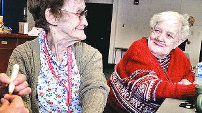 
Mary Hagy, left, looks to Virginia Haglund as she gets her nails done earlier this month. Both the women are participants in a new adult day-care program at the East Central Neighborhood Center. 
 (Jed Conklin / The Spokesman-Review)