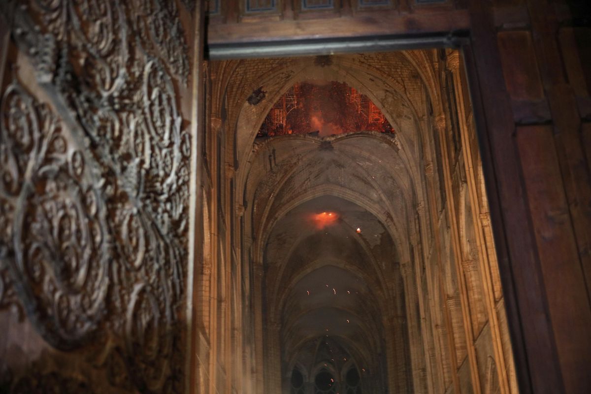 Smoke and flames are seen in the interior of Notre Dame cathedral in Paris, Monday, April 15, 2019. A catastrophic fire engulfed the upper reaches of Paris