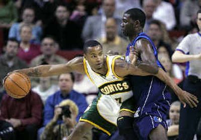 Seattle's Rashard Lewis, left, tries to drive against Mavericks' Michael Finley.
(Associated Press / The Spokesman-Review)