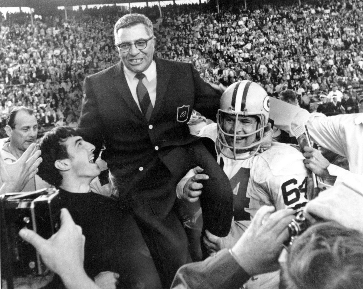 Green Bay Packers coach Vince Lombardi is carried off the field after his team defeated the Oakland Raiders 33-14 in Super Bowl II on Jan. 14, 1968, in Miami. Packers guard Jerry Kramer (64) is at right. (ASSOCIATED PRESS)