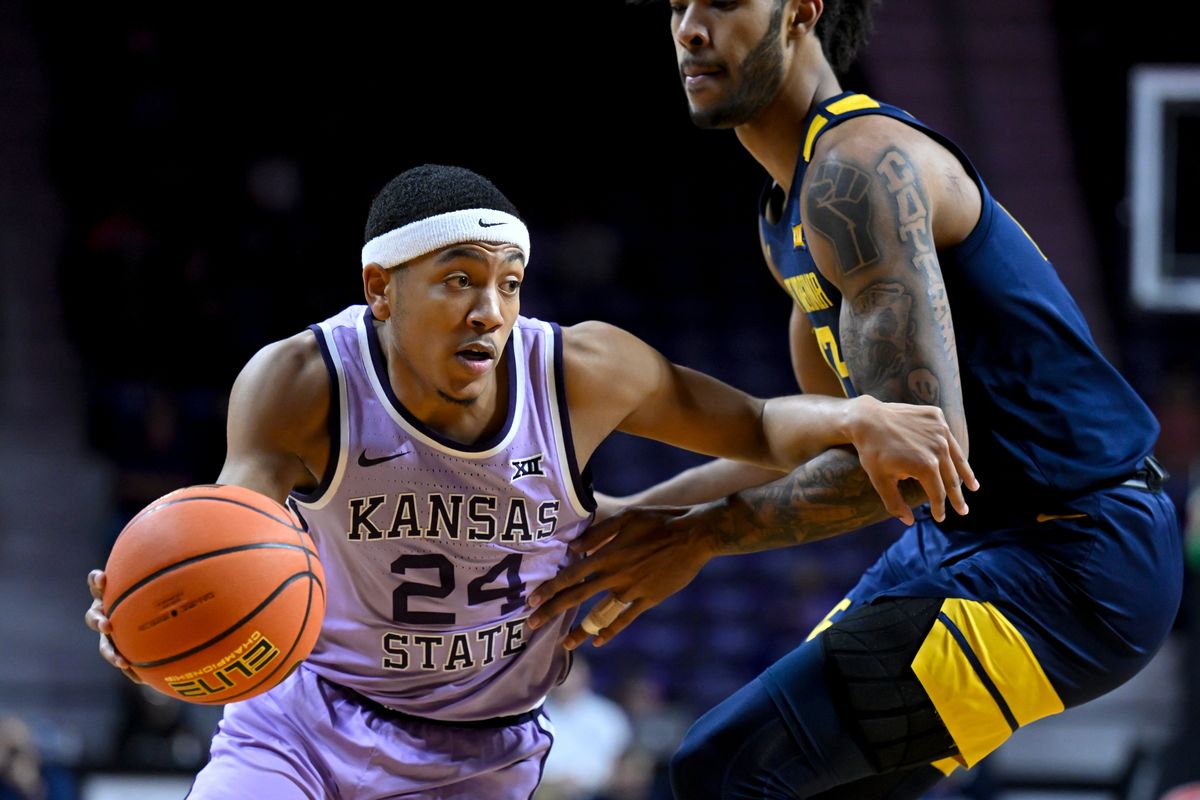 Kansas State guard Nijel Pack (24) drives around West Virginia forward Isaiah Cottrell (13) during the first half of an NCAA college basketball game in Manhattan, Kan., Monday, Feb. 14, 2022.  (Associated Press)