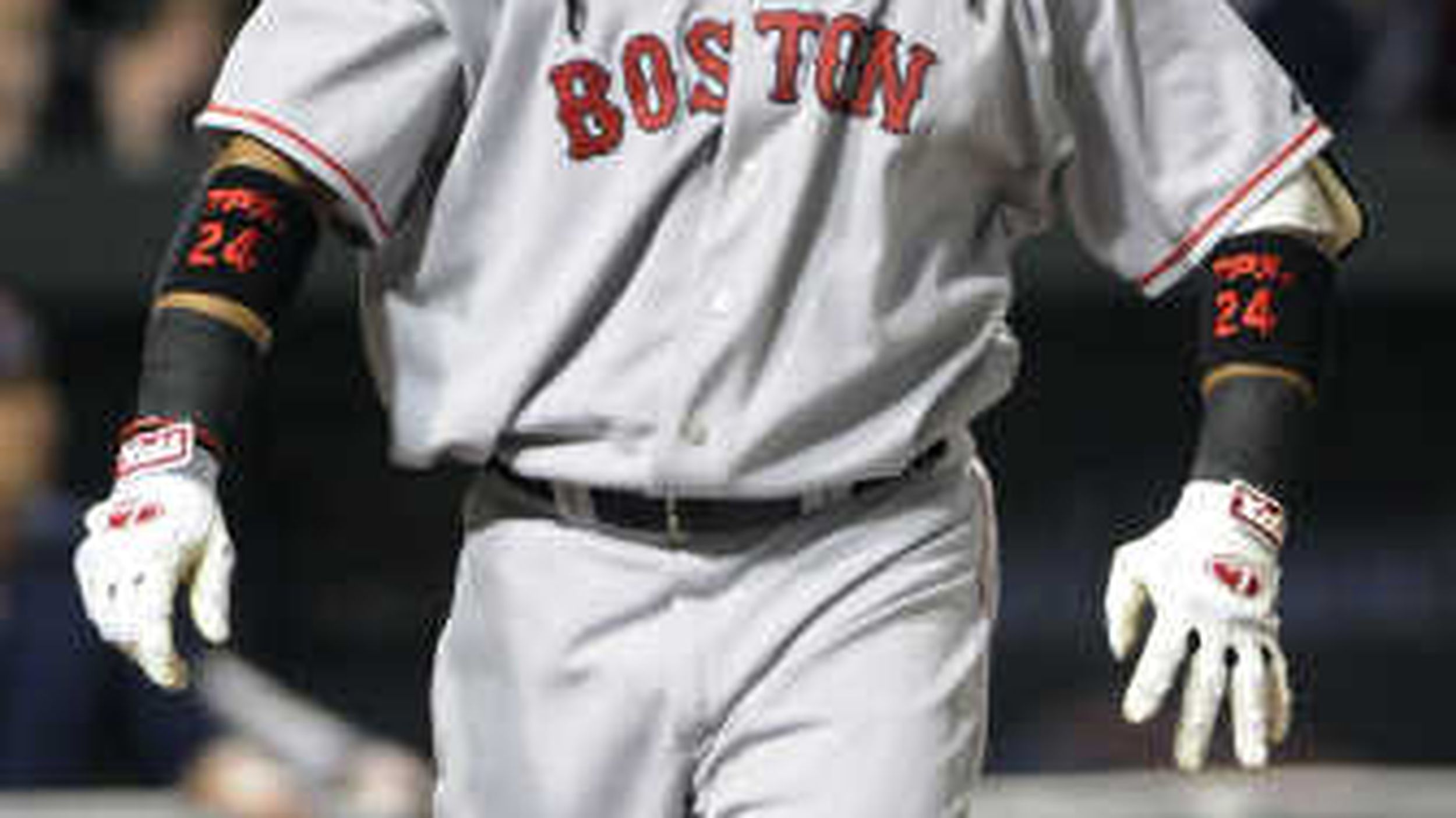 Boston Red Sox's Manny Ramirez hugs teammate David Ortiz (34