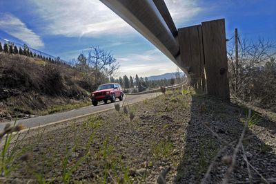 A car heads along Five Mile Road on Friday. The city and county are preparing to improve the narrow arterial.  (CHRISTOPHER ANDERSON / The Spokesman-Review)