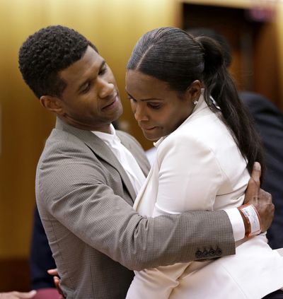 R&B singer Usher hugs ex-wife Tameka Foster Raymond after a hearing Friday. (Associated Press)