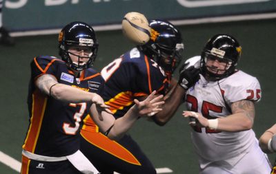 Spokane’s Casey Hansen, left, filled in briefly for quarterback Nick Davila.  (Jesse Tinsley / The Spokesman-Review)