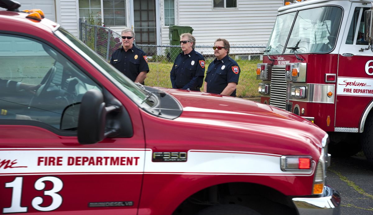 The body of Spokane Fire Department Lt. Terry Canfield is transported from the Spokane County Medical Examiner’s Office along Euclid Avenue at Lidgerwood Street on Tuesday as Station 6 firefighters Jeff Hager, Duane Flaget and Tim Ventress look on. (Dan Pelle)