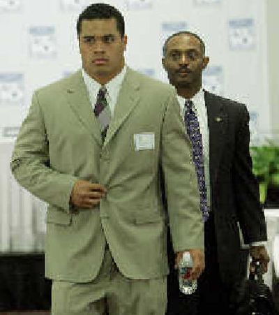 
Washington's Joe Lobendahn, left, and coach Tyrone Willingham exit after media day. 
 (Associated Press / The Spokesman-Review)