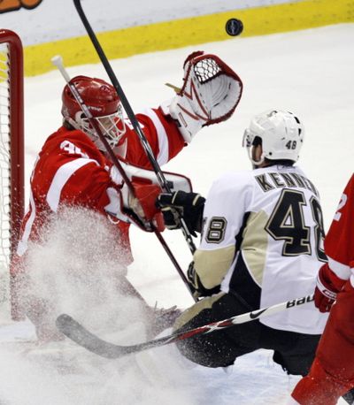 Detroit Red Wings goaltender Chris Osgood makes the save on the Pittsburgh Penguins’ Tyler Kennedy.  (Associated Press / The Spokesman-Review)