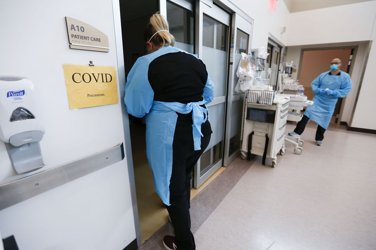 FILE - In this July 16, 2021, file photo, nurses and doctors in the CoxHealth Emergency Department in Springfield, Mo., don personal protective equipment to treat patients with COVID-19.   (Nathan Papes)