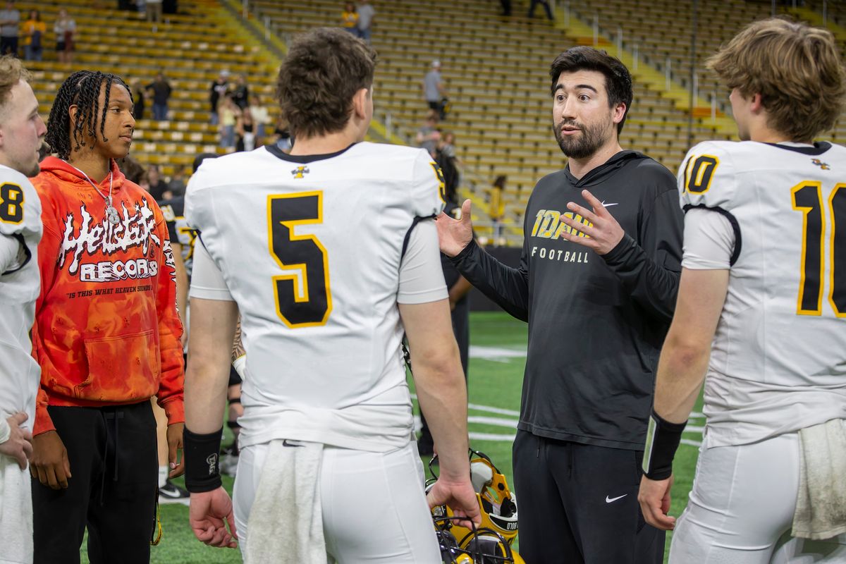 Idaho offensive coordinator Matt Linehan, second from right, talks to the team’s quarterback after the spring game on April 25, at the Kibbie Dome in Moscow, Idaho.  (Geoff Crimmins/For The Spokesman-Review)