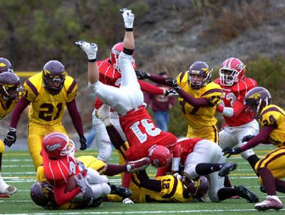 
Ferris High School's McKenzie Murphy (31) goes headfirst in the pile-up at Albi Stadium in a game against Moses Lake on Saturday. 
 (Jed Conklin / The Spokesman-Review)