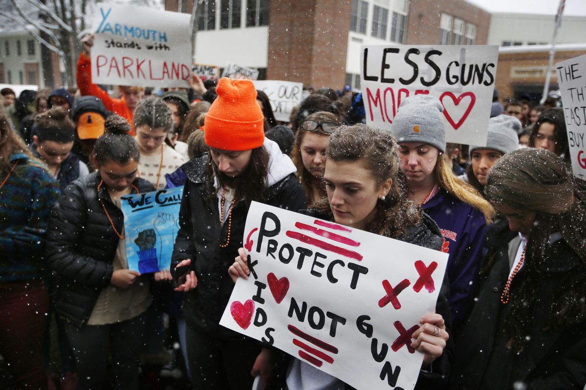 Students at Yarmouth High School observe a moments of silence in honor of those killed in the Parkland, Fla., school shooting during a walkout to protest gun violence, Wednesday, March 14, 2018, in Yarmouth, Maine. (Robert F. Bukaty / AP)