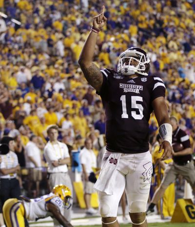 Mississippi State QB Dak Prescott threw two TDs and ran for three scores in win. (FILE)