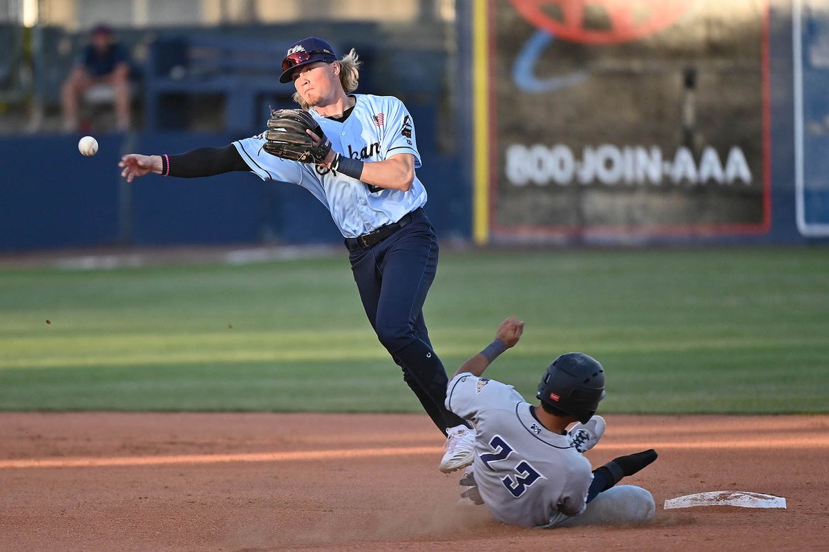 Spokane Indians infielder Aaron Schunk (22) turns the double play against Tri-City Dust Devils infielder Kyle Kasser (23) during a baseball game Friday, June 4, 2021 at Avista Stadium in Spokane WA.  (James Snook For The Spokesman-Review)