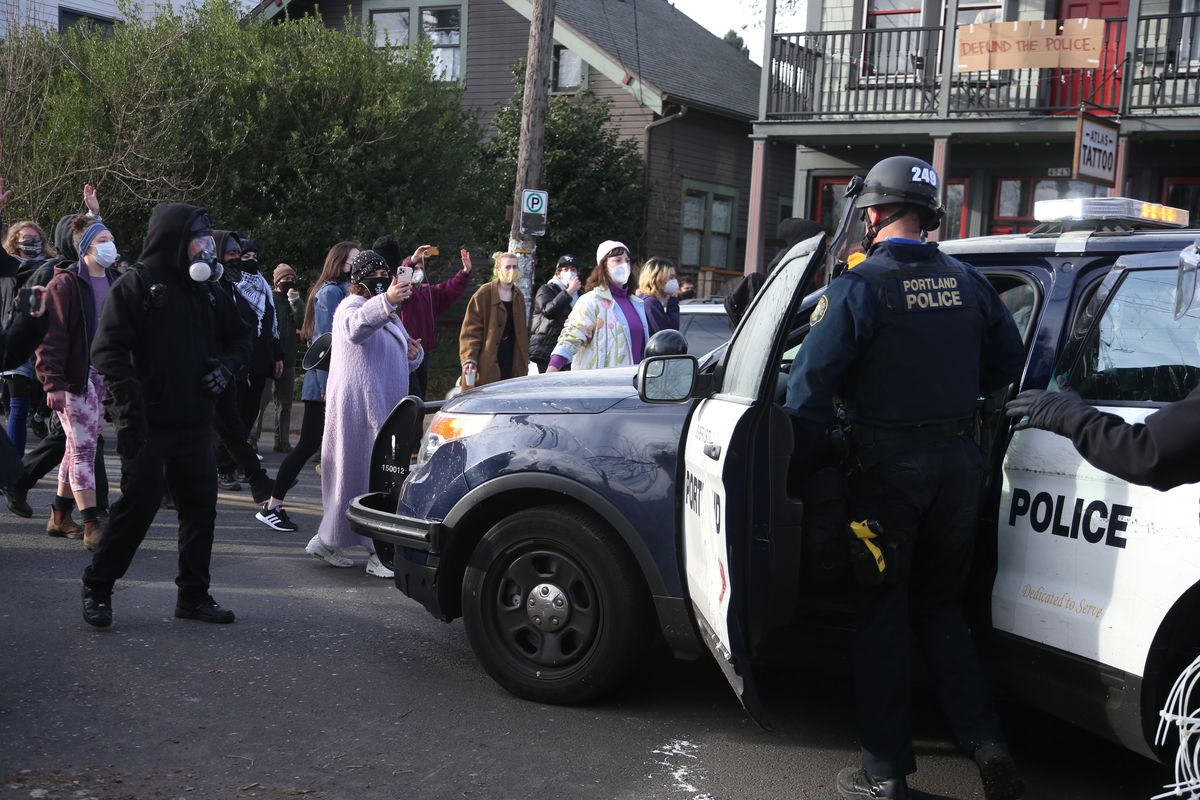 Protesters who have camped for months to prevent a Black and Indigenous family from being forced to leave a home took the property back Tuesday, Dec. 8, 2020, after morning clashes with police, who said they were working to "re-secure" the foreclosed home.  (Beth Nakamura)