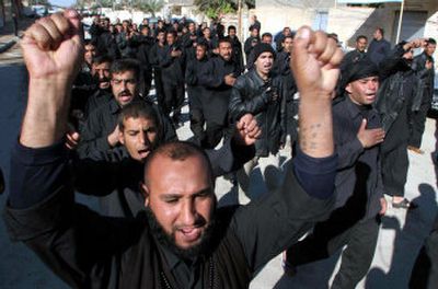 
Members of the Mahdi Army, followers of radical Shiite cleric Muqtada al-Sadr, take part in a parade Sunday in Najaf on the anniversary of Muqtada's father's death.   
 (Associated Press / The Spokesman-Review)