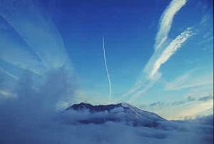 
The fresh vapor trail or "contrail" of a streaking airliner creates a linear contrast to older, more diffused trails of similar jets that have already passed over Mount St. Helens in this 1994 photo. 
 (Associated Press / The Spokesman-Review)