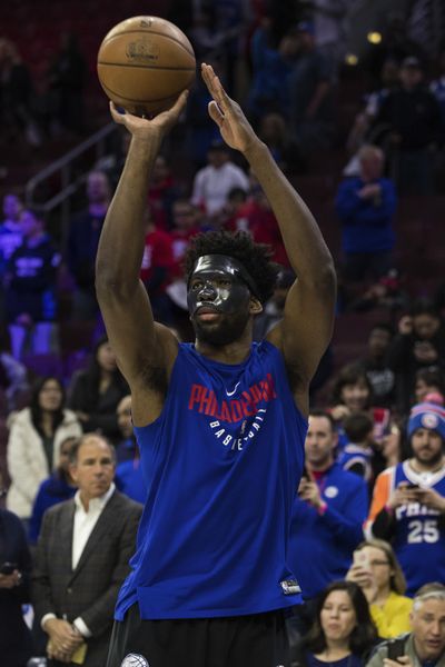 Philadelphia 76ers’ Joel Embiid wears mask while warming up for the team’s NBA basketball game against the Milwaukee Bucks, Wednesday, April 11, 2018, in Philadelphia. (Chris Szagola / Associated Press)