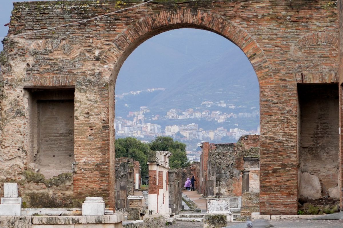 Tourists walk inside the Pompeii archaeological site on Tuesday in southern Italy.  (Gregorio Borgia)