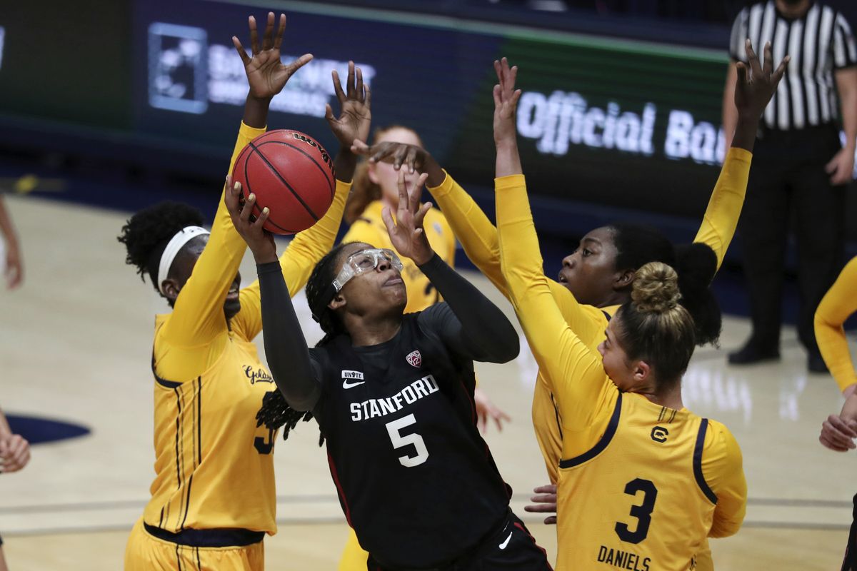 Stanford’s Francesca Belibi (5) drives against California’s Fatou Samb (33) and Dalayah Daniels (3) during the first half of an NCAA college basketball game Sunday, Dec. 13, 2020, in Berkeley, Calif.  (Jed Jacobsohn)