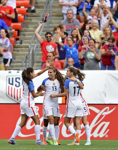 United States forward Alex Morgan, center, is congratulated by Tobin Heath, right, and Christen Press, left, after scoring a goal during the second half of an international friendly soccer match against Japan, Sunday, June 5, 2016, in Cleveland, Ohio. (Associated Press)