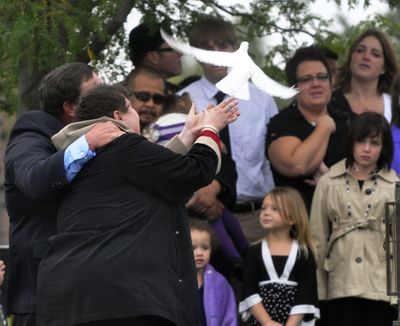 ORG XMIT: IDNCP101 Parents Robert and Connie Heckathorn releases a dove, Tuesday, Sept. 29, 2009, in memory of their 17-year-old son Shawn, as friends and family members look on during the graveside service at Canyon Hill Cemetery in Caldwell, Idaho. Heckathorn, a high school senior, died in a head-on collision with a school bus Sept. 23, 2009. (AP Photo/Idaho Press-Tribune, Mike Vogt) ** MANDATORY CREDIT ** (Mike Vogt / The Spokesman-Review)