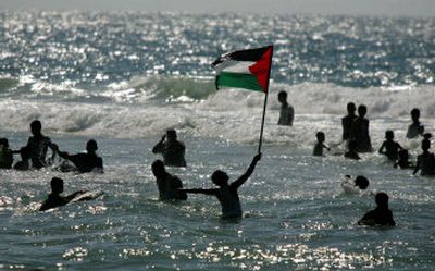 
Palestinians celebrate their freedom Monday by wading into the waters off the once-forbidden beach of the Mawasi area in the Gaza Strip. 
 (Associated Press / The Spokesman-Review)
