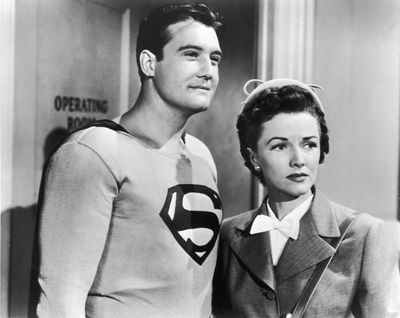 American actor George Reeves, as Superman, stands with Phyllis Coates, as Lois Lane, in a still from the television series, 