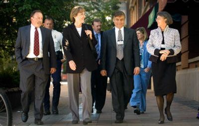 
From left, police chief finalists Bruce Roberts, Linda Eschenfelder Pierce, Roger Peterson and Anne Kirkpatrick walk to City Hall after dinner on Tuesday for a public forum. 
 (Christopher Anderson / The Spokesman-Review)