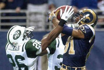 
Rams receiver Torry Holt catches a 44-yard TD pass over Jets defender Erik Coleman, left, and David Barrett.
 (Associated Press / The Spokesman-Review)