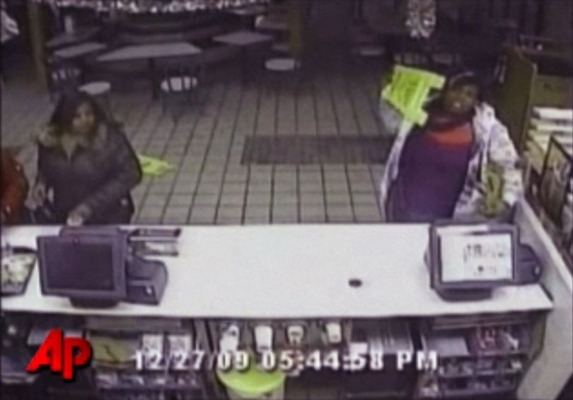 In this Dec. 27, 2009 still made from video provided by the Kansas City, Mo. Police shows a woman getting ready to throw a sign as she goes on a rampage at a McDonald's in Kansas City because she didn't like her hamburger. Police say the woman caused thousands of dollars in damage when she became upset that the restaurant wouldn't refund her money. (Courtesy Kansas City, Mo. Police)