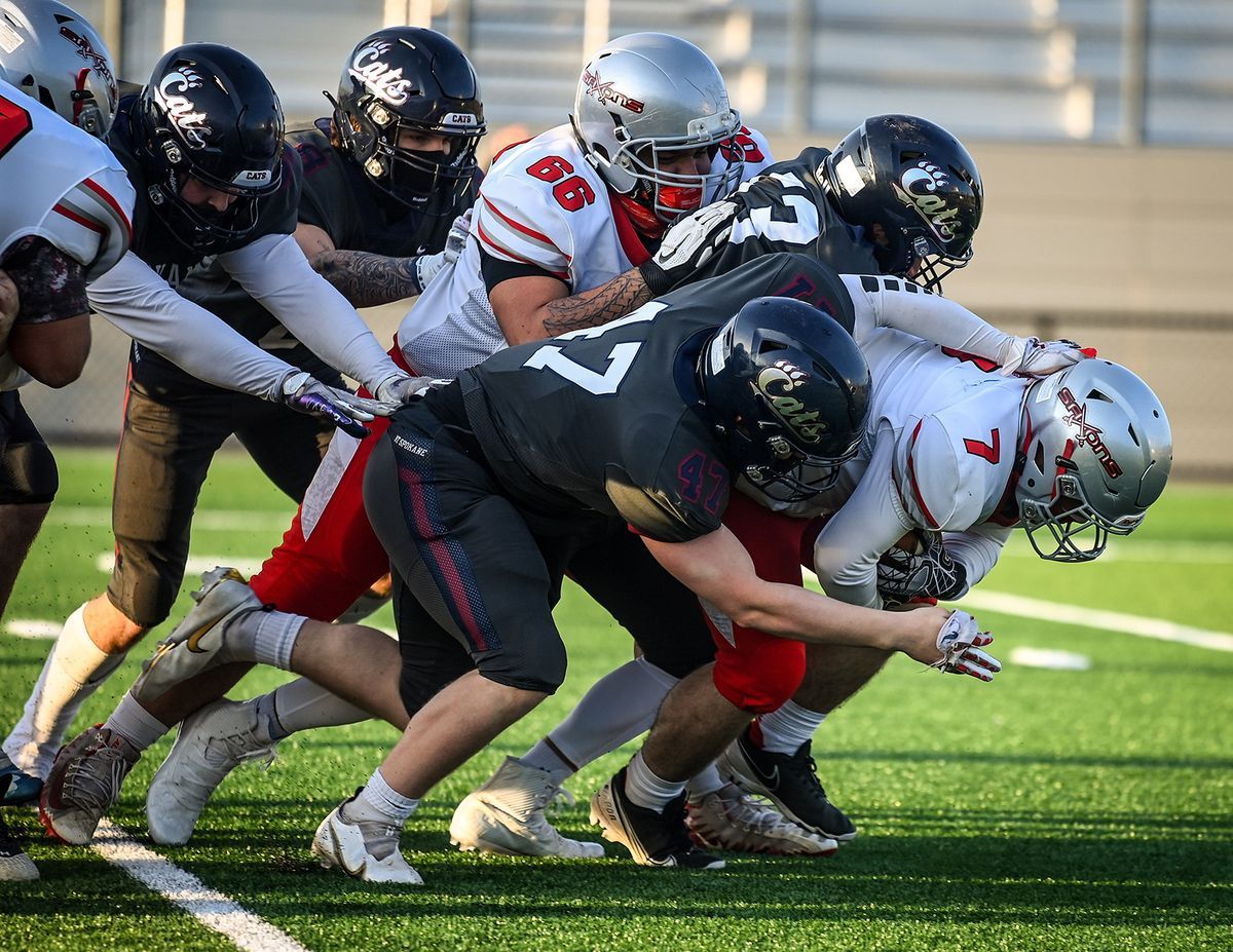 Mt. Spokane linebacker Jackson Kink, center, tackles Ferris running back Charlie Markham during the first half of a GSL game last Friday at Union Stadium in Mead. (Colin MulvaneyThe Spokesman-Review)