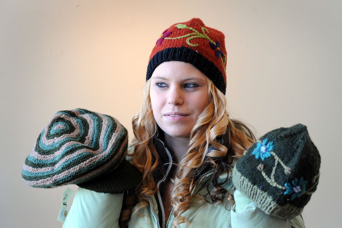 Desiree Dunham models a selection of hats knitted by women in Nepal that are sold at Kizuri, a fair trade store in the Community Building in downtown Spokane. Merchandise like this will be sold at the Festival of Fair Trade next weekend. (Jesse Tinsley)