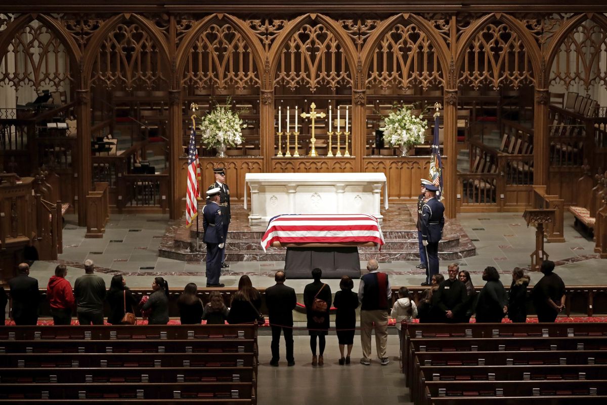 Visitors pay their respects to the flag-draped casket of former President George H.W. Bush at St. Martin’s Episcopal Church, Wednesday, Dec. 5, 2018, in Houston. (Mark Humphrey / Associated Press)