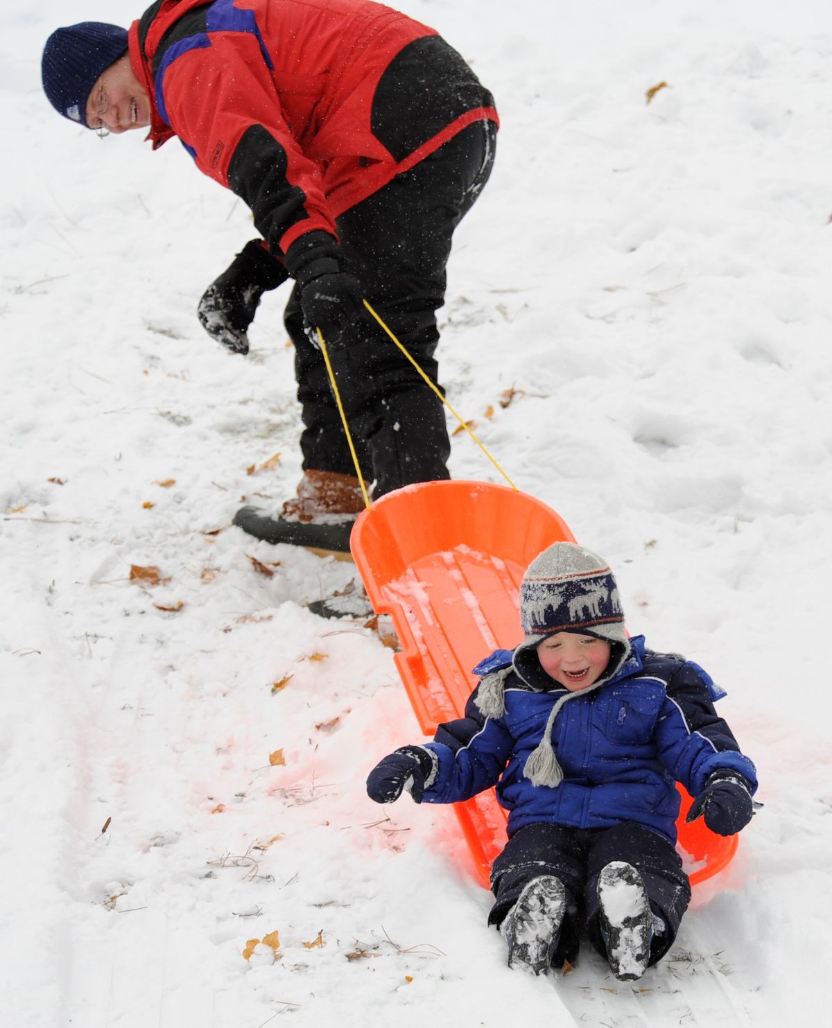 Christopher Mingeaud, left, struggles to get his son, Benjamin Mingeaud, 3, up a small sledding hill on Nov. 22, 2010, at Manito Park.  (JESSE TINSLEY/The Spokesman-Review)