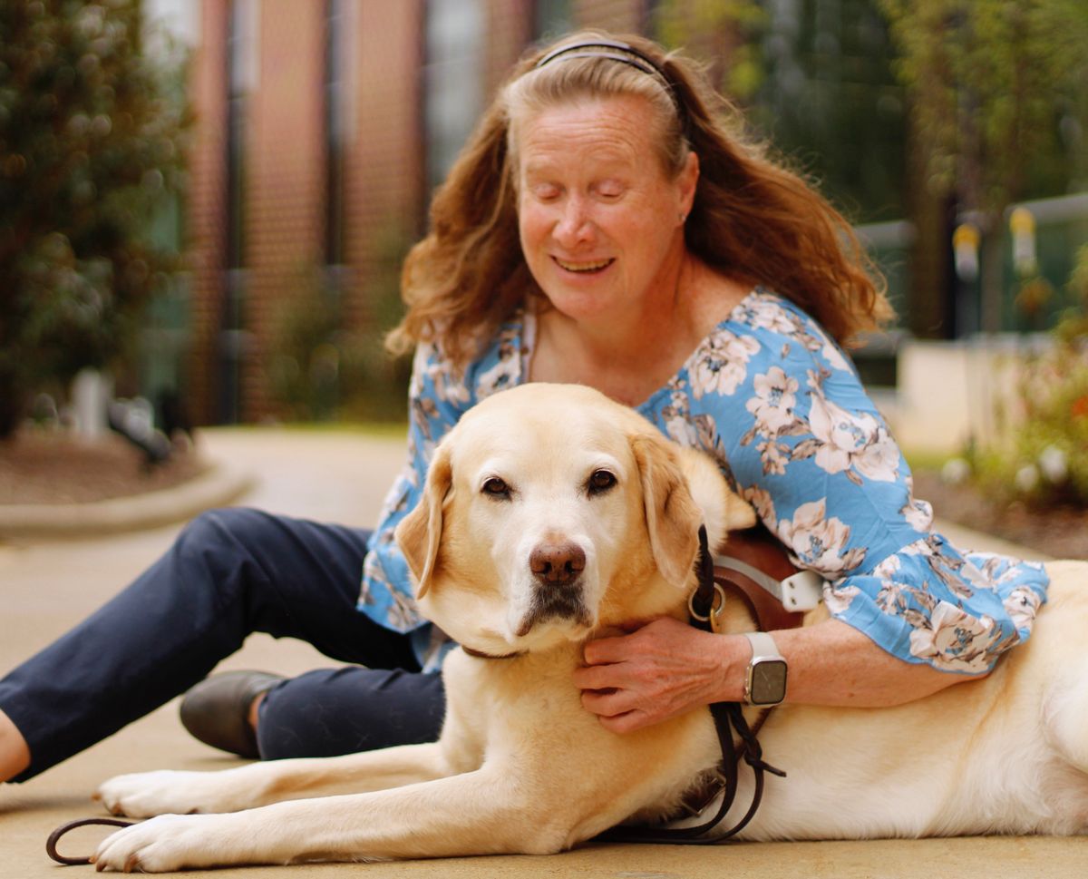 1975 March of Dimes poster child Jamie Weaver, now an associate professor at Stephen F. Austin State University in Nacogdoches, Texas, poses for a photo with her guide dog, Plantain. Weaver said Plantain is her seventh guide dog from Guide Dogs for the Blind Inc.  (Courtesy of Jamie Weaver)