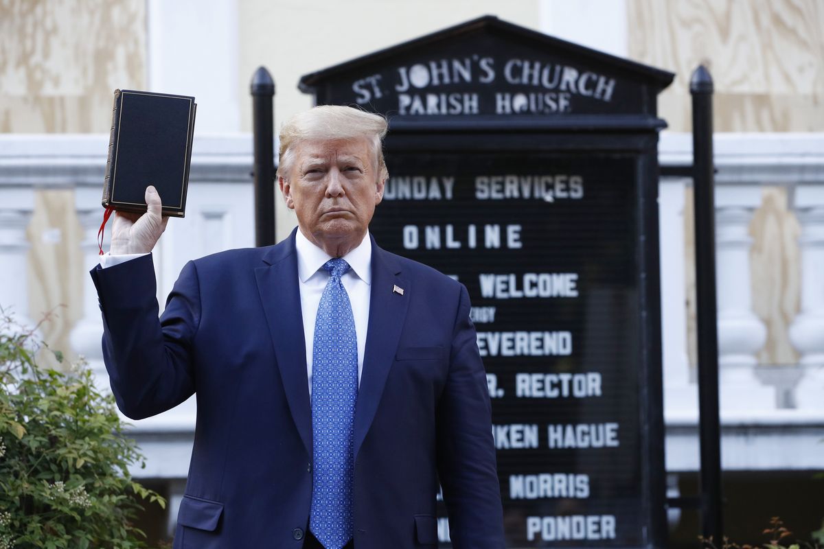 FILE - In this June 1, 2020, file photo President Donald Trump holds a Bible as he visits outside St. John