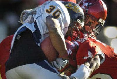 
Adam Macomber forces a fumble. 
 (Christopher Anderson / The Spokesman-Review)
