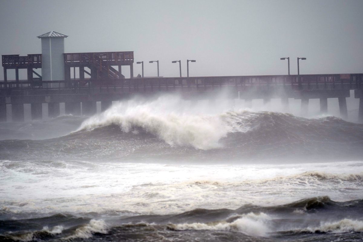 Waves crash near a pier, at Gulf State Park, Tuesday, Sept. 15, 2020, in Gulf Shores, Ala. Hurricane Sally is crawling toward the northern Gulf Coast at just 2 mph, a pace that