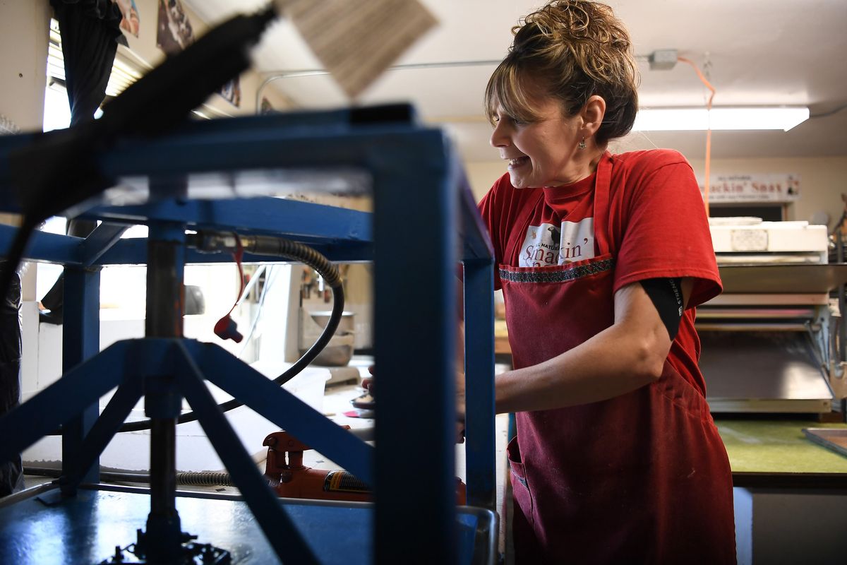 Lucy Gladhart owner of Kritters Kookies, manufacturer of SmackinÕ Snax works to prepare pet treats on Thursday, March 19, 2020, at Kritters Kookies in Deer Park, Wash.  Tyler Tjomsland/THE SPOKESMAN-REVIEW (Tyler Tjomsland / The Spokesman-Review)