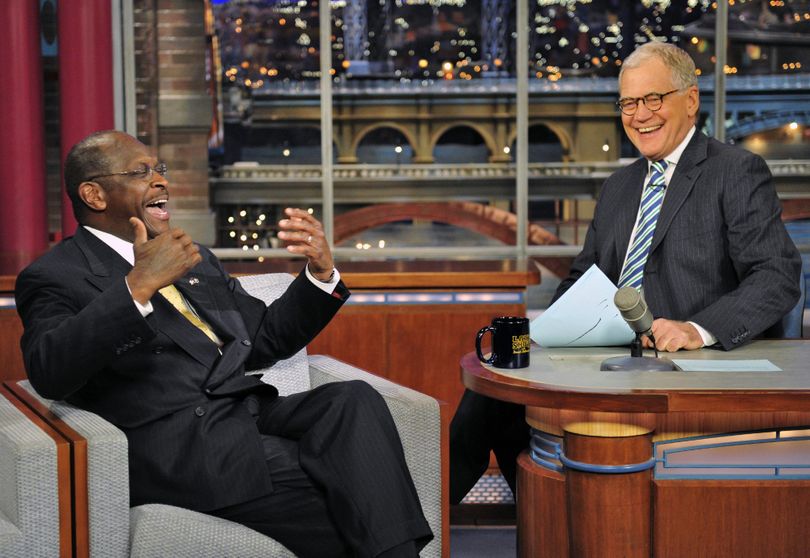 In this photo provided by CBS, Republican presidential candidate Herman Cain joins host David Letterman on the set of the �Late Show with David Letterman,� Thursday, Nov. 17, 2011 in New York. The show airs Friday, Nov. 18. (John Filo / Cbs)