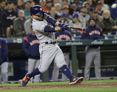 Houston Astros’ Jose Altuve hits a grand slam against the Seattle Mariners during the sixth inning of a baseball game Friday, April 12, 2019, in Seattle. (Ted S. Warren / Associated Press)