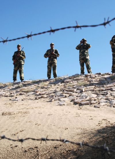 Indian Border Security Force soldiers keep vigil along the India-Pakistan border on Thursday.  (Associated Press / The Spokesman-Review)