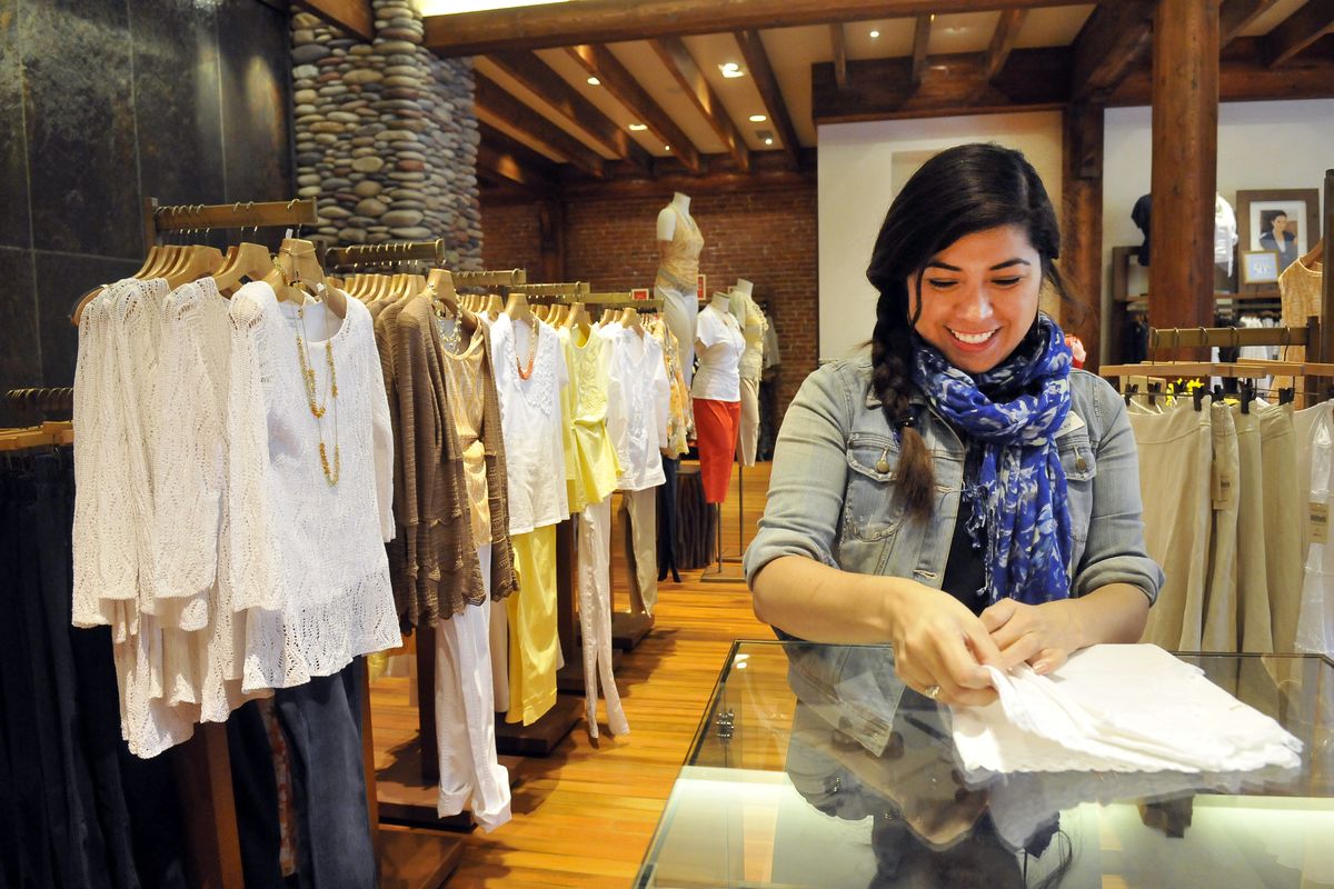 Store manager Violet Rodriguez folds a top at the Coldwater Creek store in Sandpoint on Thursday. The women’s clothing retailer is revamping it collections and refocusing its marketing. (Jesse Tinsley)