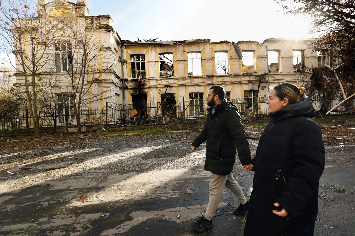 Ludmila Taranov, left, and Viacheslav Slavov take a walk after Kherson