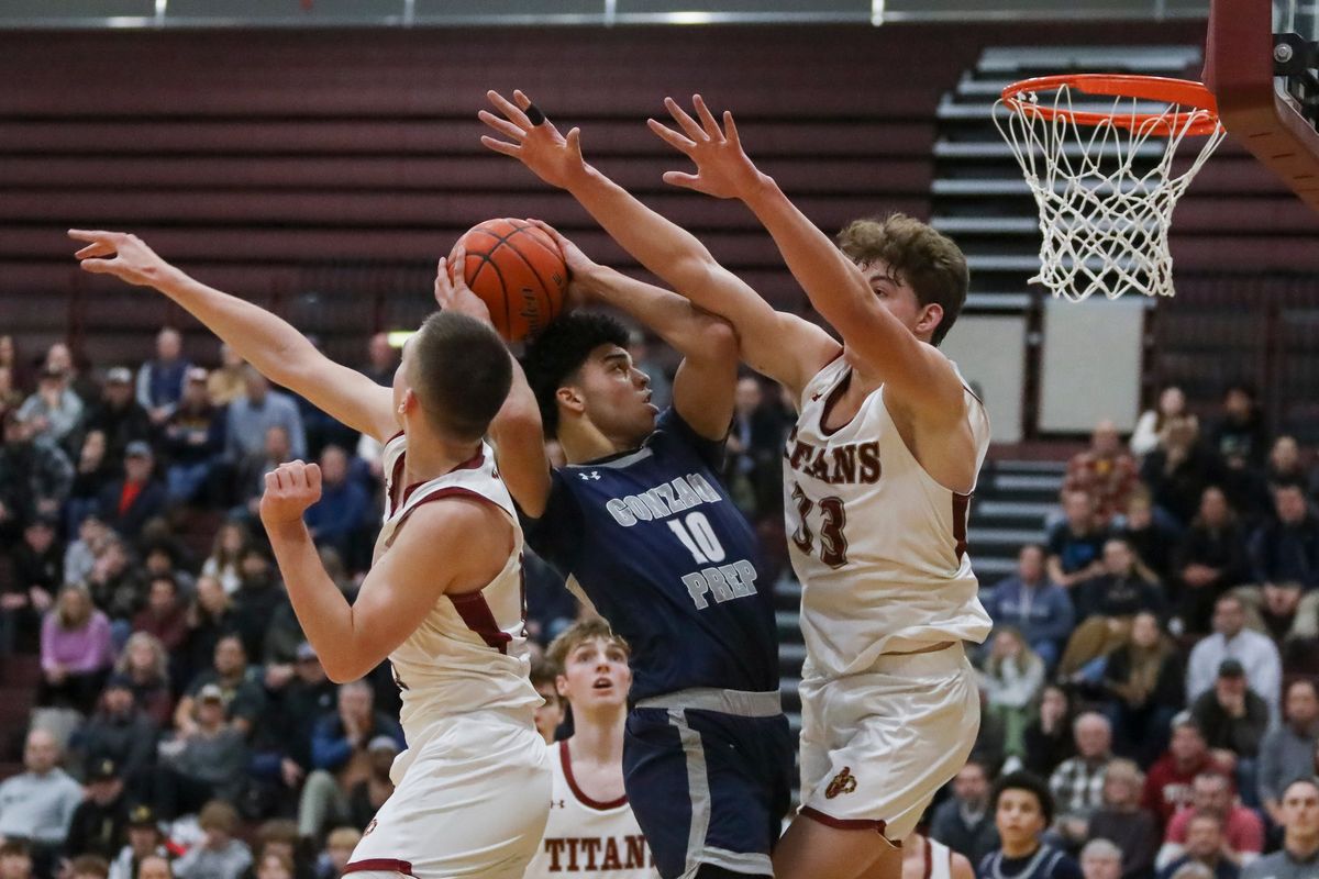 Gonzaga Prep’s Jamil Miller, who scored 23 points, fights University post Shane Skidmore to get off his shot off on Thursday.  (CHERYL NICHOLS/For The Spokesman-Review)