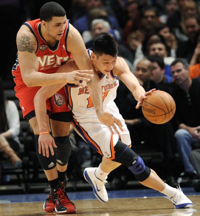 Knicks guard Jeremy Lin pushes the ball upcourt against Nets forward Jordan Williams earlier this month. (Associated Press)